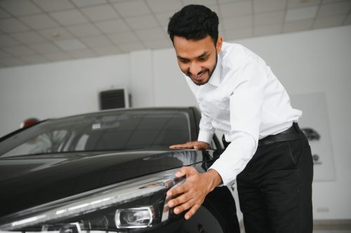 happy-indian-man-checking-car-features-at-showroom-2023-09-11-19-55-21-utc (2)